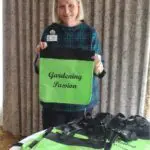 Woman holding a green bag saying gardening passion