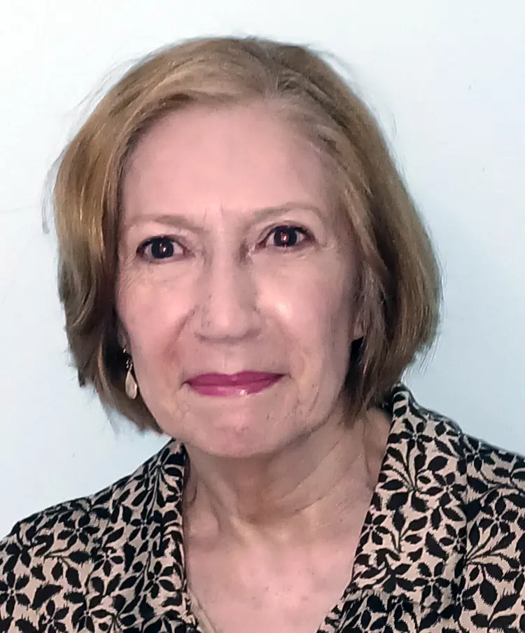 A woman with short hair and wearing a black and white shirt.