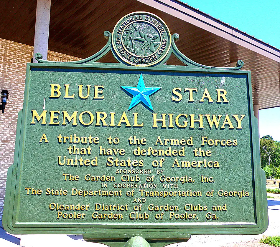 A green sign with the words blue star memorial highway.