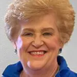 Portrait of an elderly woman smiling.