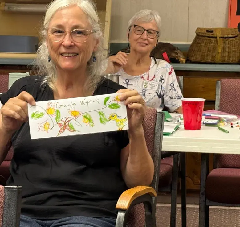 Magnolia District member Gayle Wyrick proved to be quite the artist. Her sister Marilyn Aldrich, Magnolia DD, looks on. 