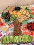 Tree-shaped snack platter with fruits and crackers.