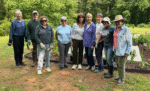 Group of people posing in a garden.